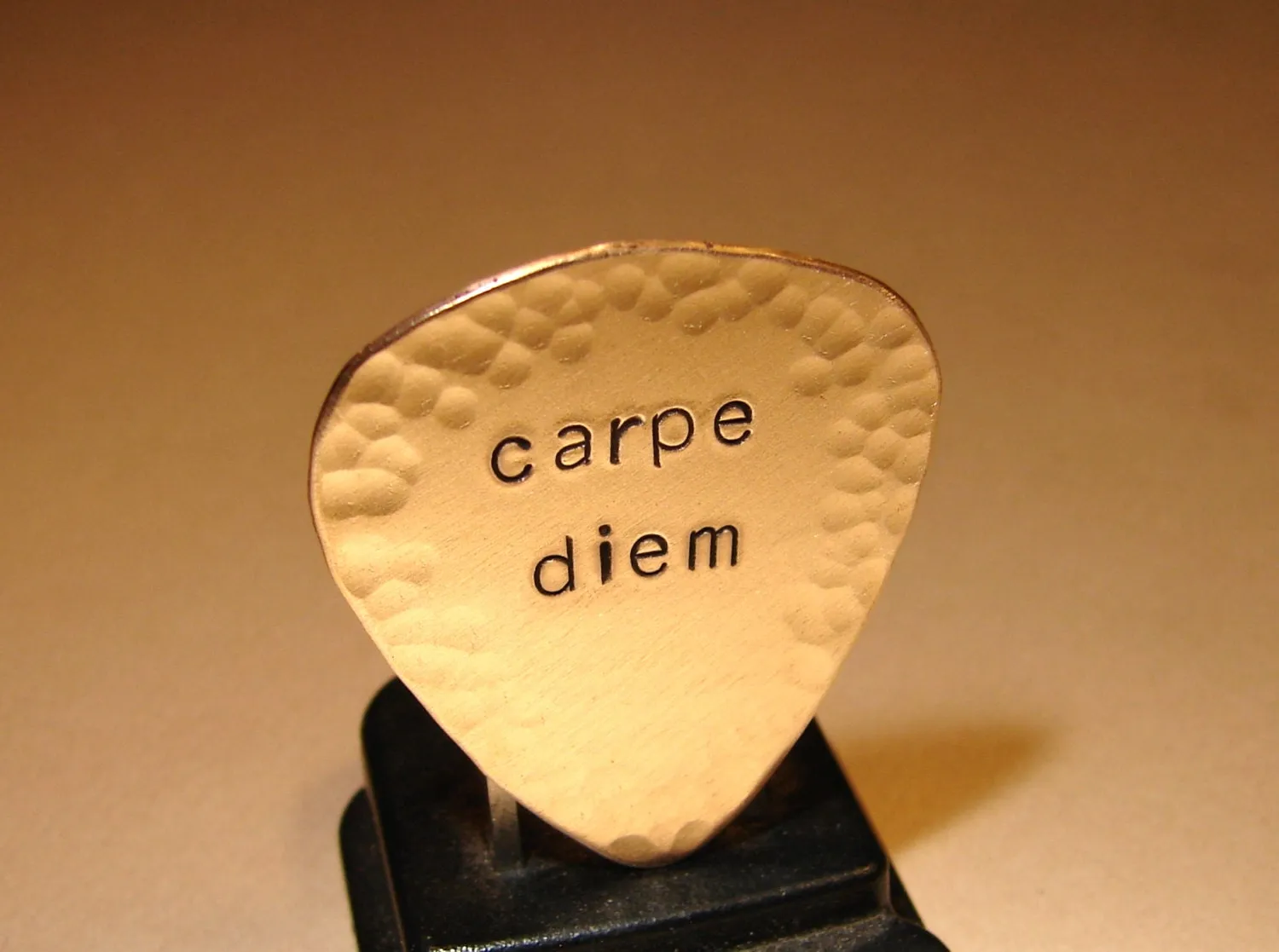 Carpe diem guitar pick with hammered edges in bronze