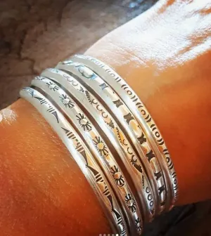 Sterling silver stacking bracelets with hand stamped patterns as singles or a set