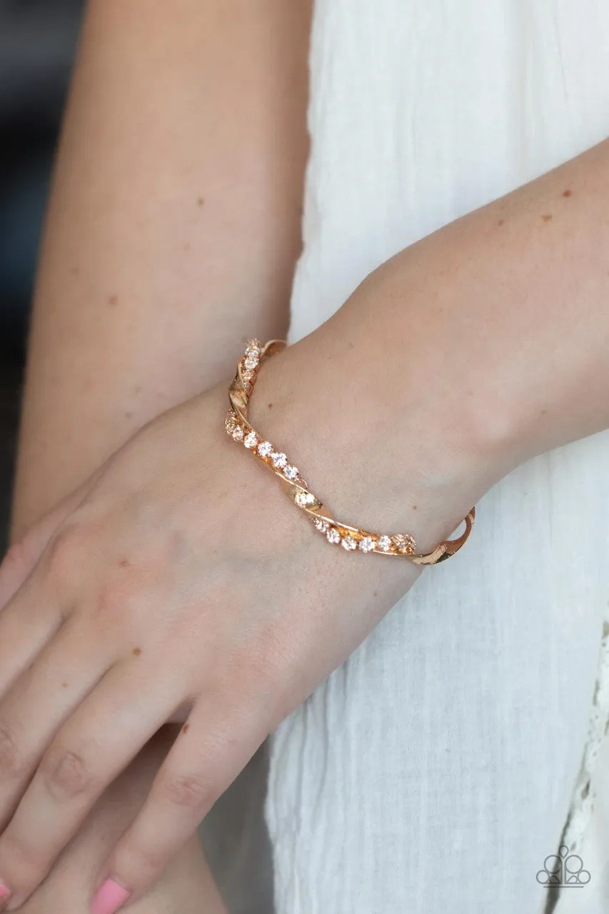 Twisted Twinkle - Gold - White Rhinestone Warped Paparazzi Cuff Bracelet